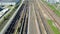 Flying above industrial railroad station with cargo trains and freight containers. Railroads and shipping container trains