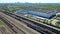 Flying above industrial railroad station with cargo trains and freight containers. Railroads and shipping container trains