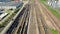 Flying above industrial railroad station with cargo trains and freight containers. Railroads and shipping container trains