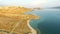 Flying above isolated house in yellow grass of Pag island at sunset, Croatia