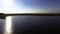 Flying above lake with water reflection