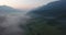 Flying above mist covered valley.