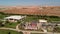 Flying from above over the hotel and the desert near Hurghada. Top view of residential buildings, swimming pools for tourists.