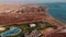 Flying from above over the hotel and the desert near Hurghada. Top view of residential buildings, swimming pools for tourists.