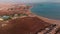 Flying from above over the hotel and the desert near Hurghada. Top view of residential buildings, swimming pools for tourists.