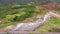 Flying above Strokkur geysir in Iceland, aerial high angle drone view