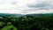 Flying above suburban homes in the forest.