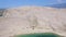 Flying above tourists on isolated beach of Pag island, Croatia