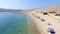 Flying above tourists on isolated beach of Pag island, Croatia