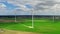 Flying above white wind turbines in spring, Poland