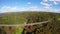 Flying along side old steel bridge, railroad train road aerial