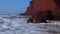 Flying through the arch on Legzira beach with arched rocks on the Atlantic coast in Morocco