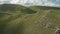 Flying around a large rock formation among the green fields. Russia. North Caucasus