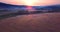 Flying backwards above, aerial view of a field with hay stacks. Sundown. Russia