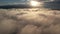 Flying backwards over sunrise cloudscape