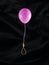 Flying balloon with gallows rope, noose or hangman knot on black background. Abstract creative emotional concept of suicide