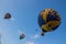 Flying balloon with passengers in a basket against the blue sky at the festival of Aeronautics summer evening in Pereslavl-Zalessk