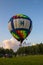 Flying balloon with passengers in a basket against the blue sky at the festival of Aeronautics summer evening in Pereslavl-Zalessk