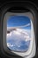 Flying into blue sky and sea of clouds and Wing of airplane with