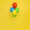 Flying bunch of Colorful Balloons isolated on yellow background. Party, gift, birthday, or celebration concept
