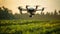 a flying camera drone hovering over a field of crops and a sunset