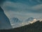 Flying Canadian geese on a blue sky over the Rocky mountains and Bow lake coniferous woods. Rocky mountains, Alberta