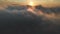 Flying through the clouds at dusk or dawn. Flying in pink clouds in the sun. Aerial view. North Caucasus