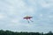 Flying colorful children`s kite, dark sky with clouds