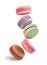 Flying colorful macaroons on a white background