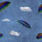 Flying colorful umbrellas on blue sky