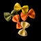 Flying colourful farfalle pasta isolated on black background