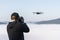 flying a copter in the fog on a cloud cover a male photographer takes pictures of a drone hovering in a thick fog in the