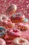 Flying donuts. Mix of multicolored doughnuts with sprinkles on pink background
