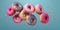 flying donuts with sprinkles isolated on blue background