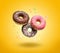 Flying donuts on yellow background.