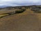 Flying drone above colorful autumn sangiovese grapes vineyards near wine making town Montalcino, Tuscany, rows of grape plants