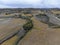 Flying drone above colorful autumn sangiovese grapes vineyards near wine making town Montalcino, Tuscany, rows of grape plants