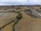 Flying drone above colorful autumn sangiovese grapes vineyards near wine making town Montalcino, Tuscany, rows of grape plants