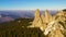 Flying drone above rocky mountain top.