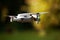 A flying drone. Airborne quadcopter. Also known as a drone or UAV, Unmanned Aerial Vehicle. Drone with camera.