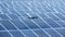 Flying Drone inspection explores the work of solar cell panel with strong sun and sky in solar farm