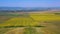 Flying drone over the hill in a summer rural landscape