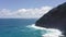 Flying drone over the ocean. View of makapuu lighthouse. Waves of Pacific Ocean wash Rocky shore. Magnificent mountains