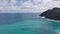 Flying drone over the ocean. View of makapuu lighthouse. Waves of Pacific Ocean wash Rocky shore. Magnificent mountains