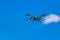 Flying drone or quad copter in clear blue sky