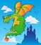 Flying fairy tale dragon near castle