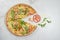 Flying food concept. seafood Pizza with fresh arugula leaves, shrimps, tomato and Parmesan cheese slices