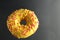 Flying food doughnut berliner in yellow glaze on a black background with a place for text and copyspace