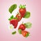 Flying Fresh tasty ripe strawberry with green leaves isolated