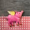 Flying happy pink pig on wooden old checked background.